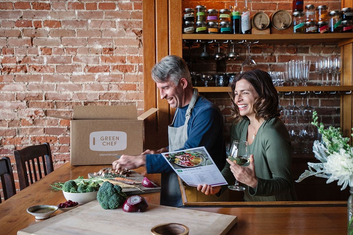 A couple prepares a meal together in their kitchen.