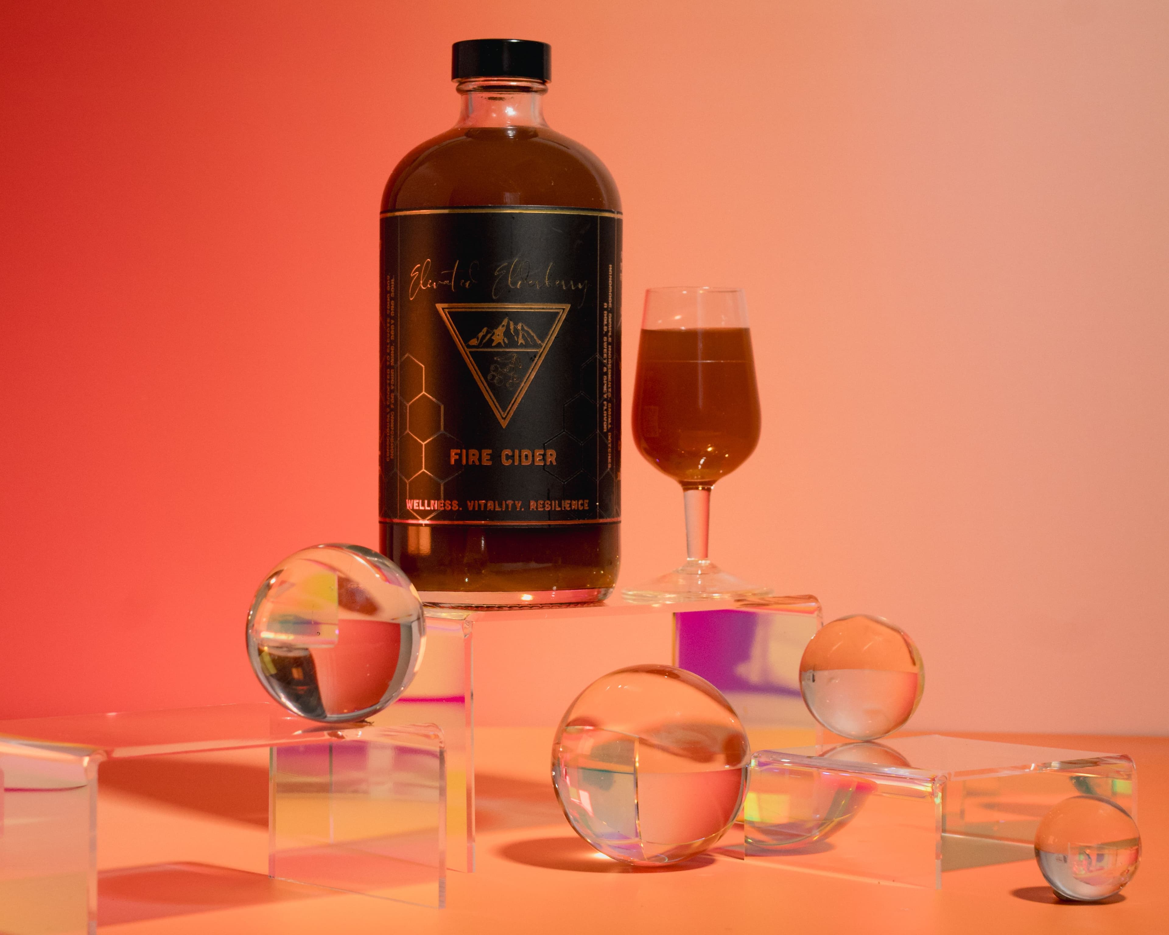 Fire Cider product Styled on a Warm gradient background