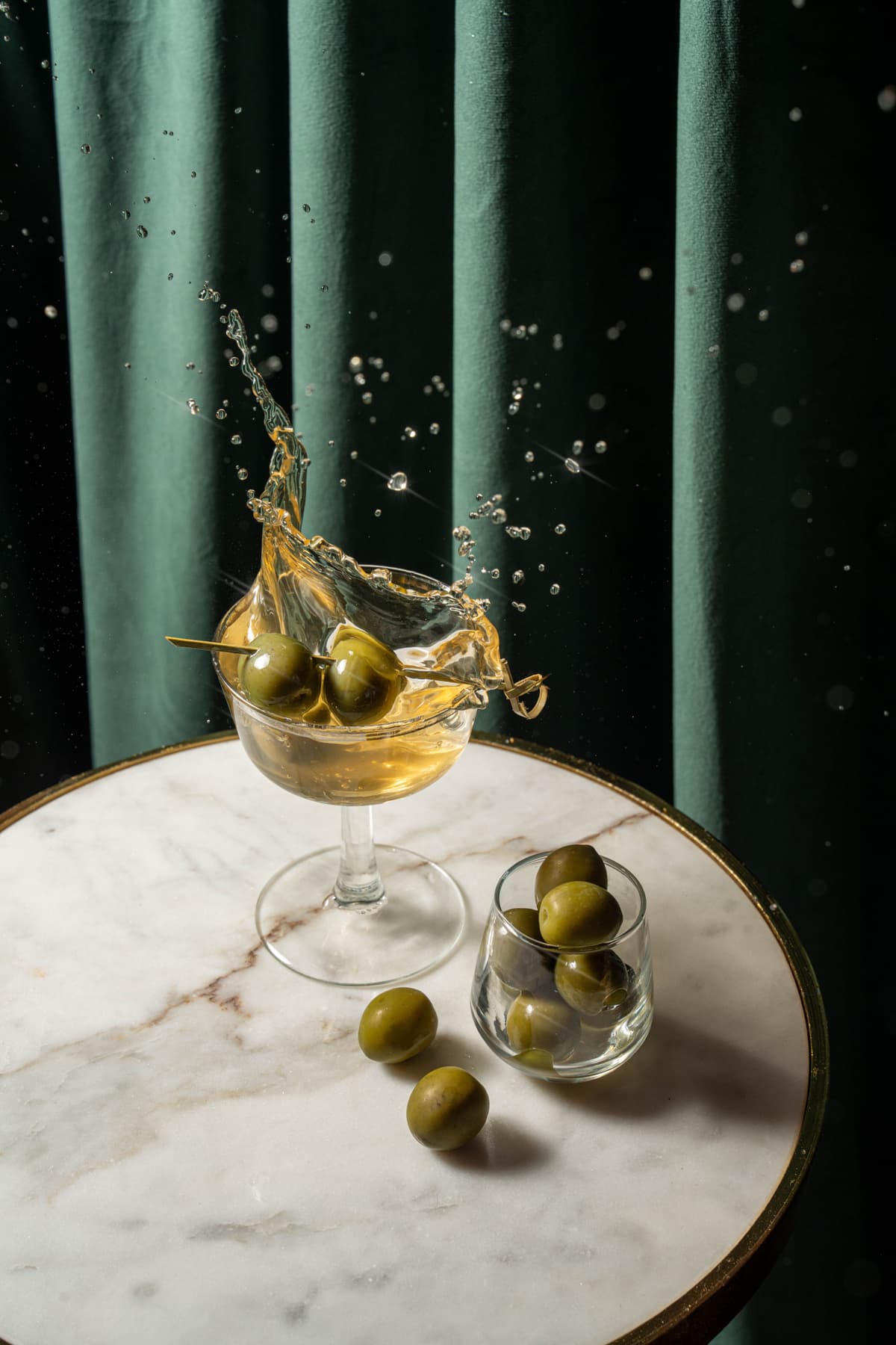 Olive splash into martini