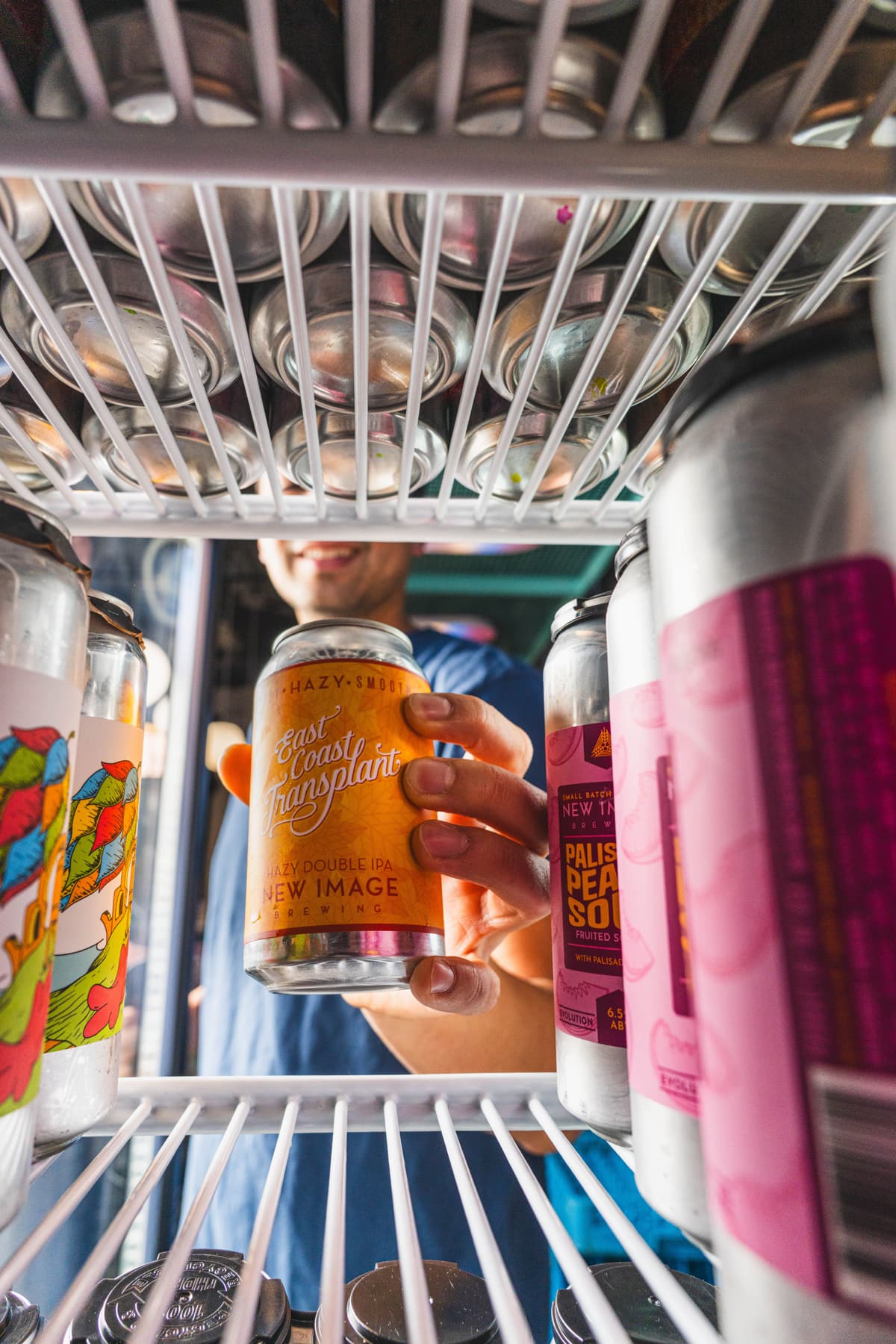 Beer being grabbed from fridge