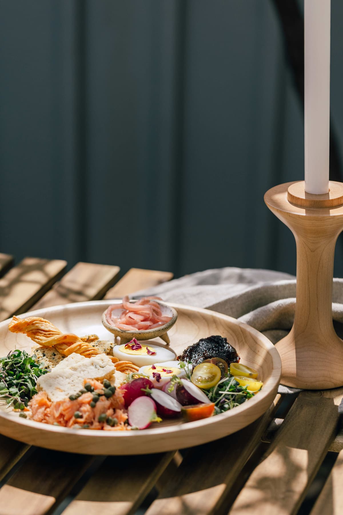 A charcuterie plate on a sunny day.