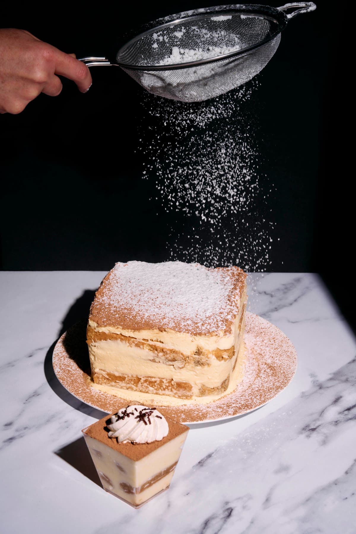 powdered sugar sprinkled on top of a tiramisu.
